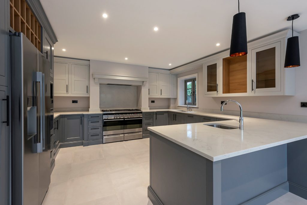 Image of the white and dust grey Belgravia kitchen design, featuring the Carrara Quartz kitchen worktop.