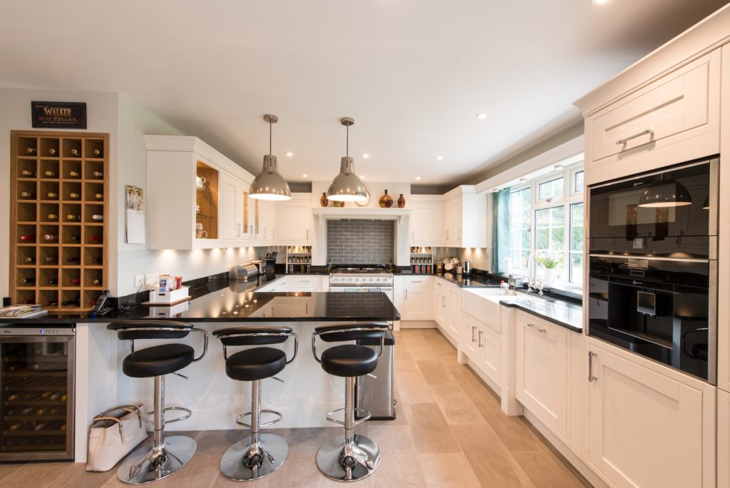 An image of a white kitchen design with a coffee machine appliance.