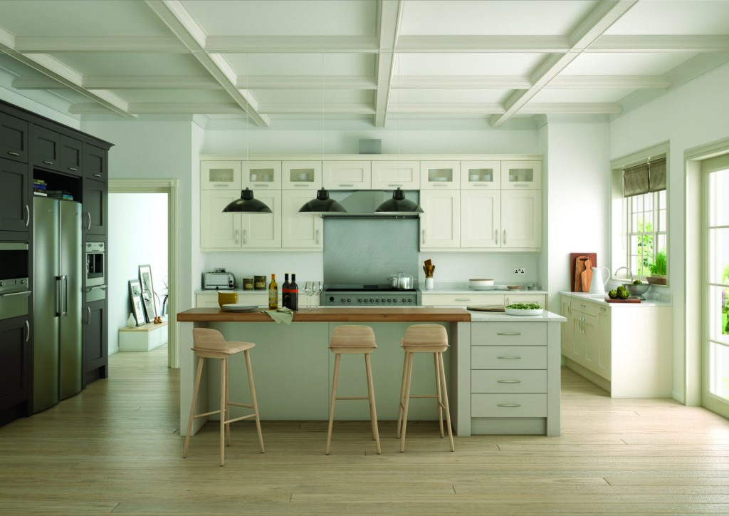 A traditional kitchen with white cabinets and wooden dining table and chairs and a white kitchen worktop.