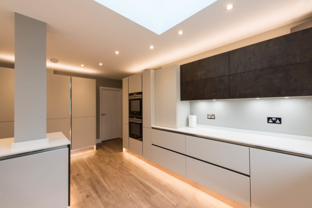 A modern kitchen with plinth and under cupboard lighting