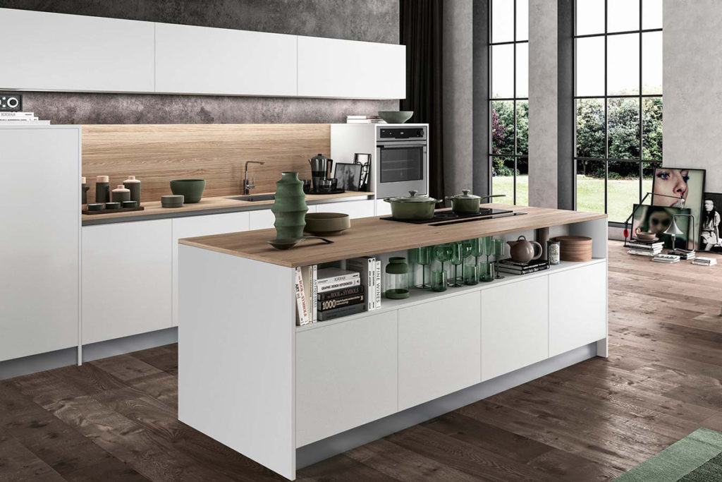 A white modern kitchen island with wooden worktop and shelving 