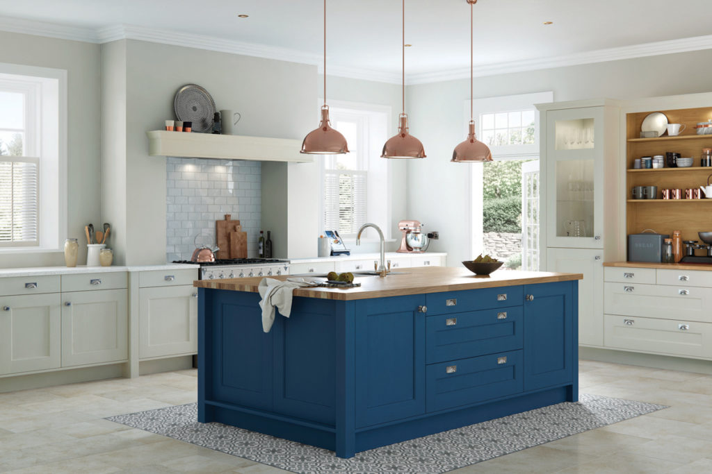 A classic kitchen with navy blue kitchen island and wooden worktop.