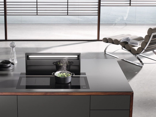 A kitchen with hob and downdraft extractor.