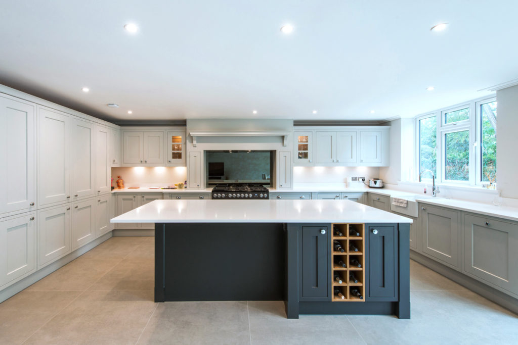 A classic shaker kitchen with a dark grey kitchen island with storage and wine rack.
