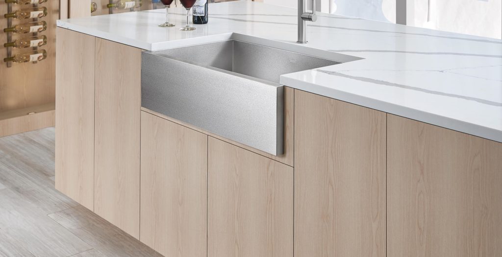 A stainless steel single sink in a wood look contemporary kitchen