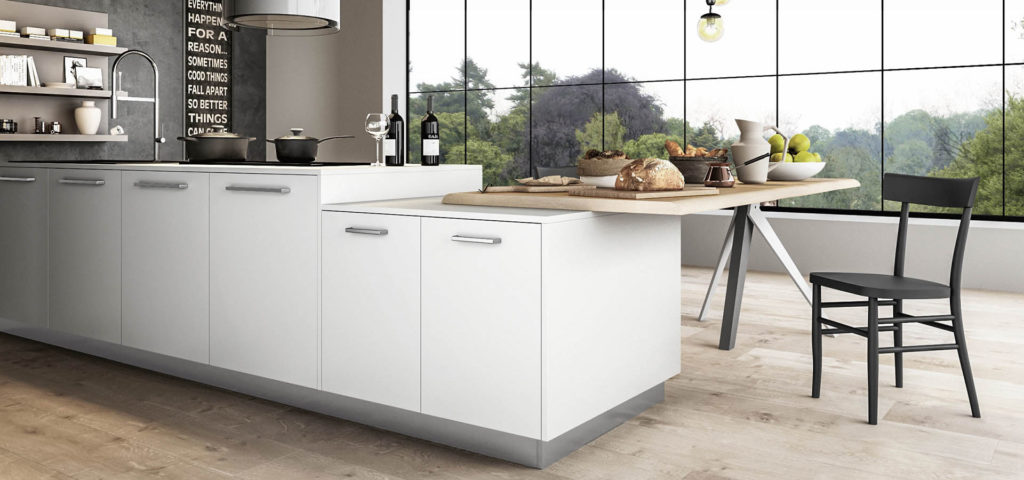 A modern white kitchen with wooden breakfast bar and large window