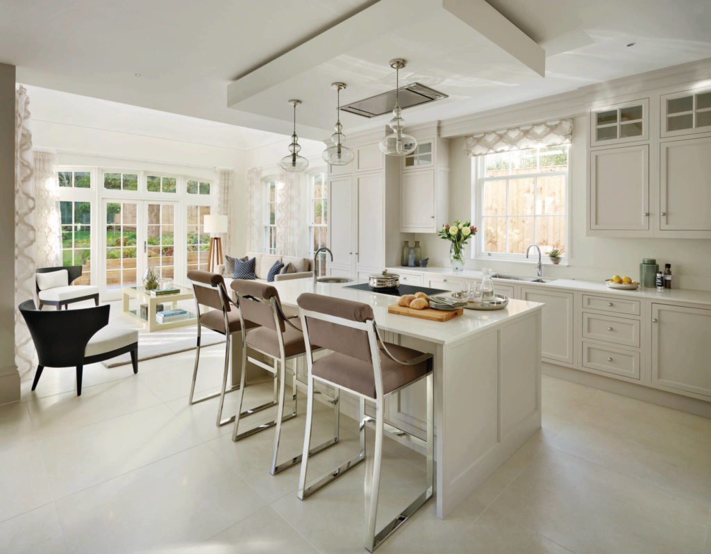 A white traditional kitchen with quartz worktops and island seating