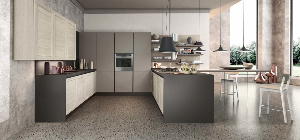 A contemporary stone-coloured kitchen with statement lighting and breakfast bar seating